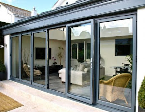 Aluminium folding sliding glass doors and windows opening onto a patio in Ghana