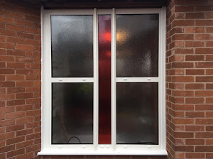 White UPVC window frame installed on a building in Ghana