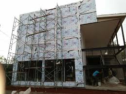 Building construction showing roofline and cladding installation by Alucobond Ghana