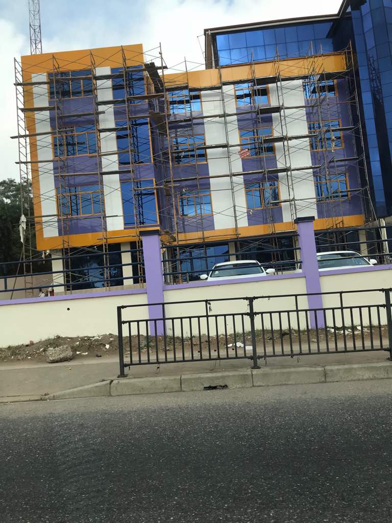 Completed building construction showing roofline and facade details in Accra Ghana