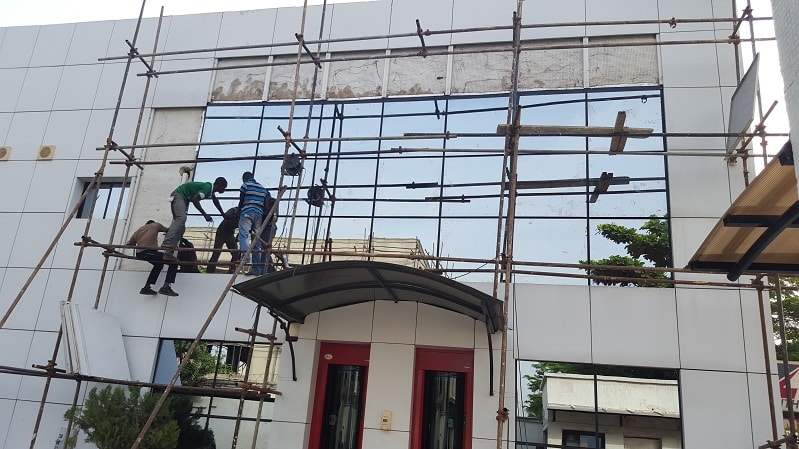 Alucobond Ghana installation crew fitting composite panels on a building facade in Ghana