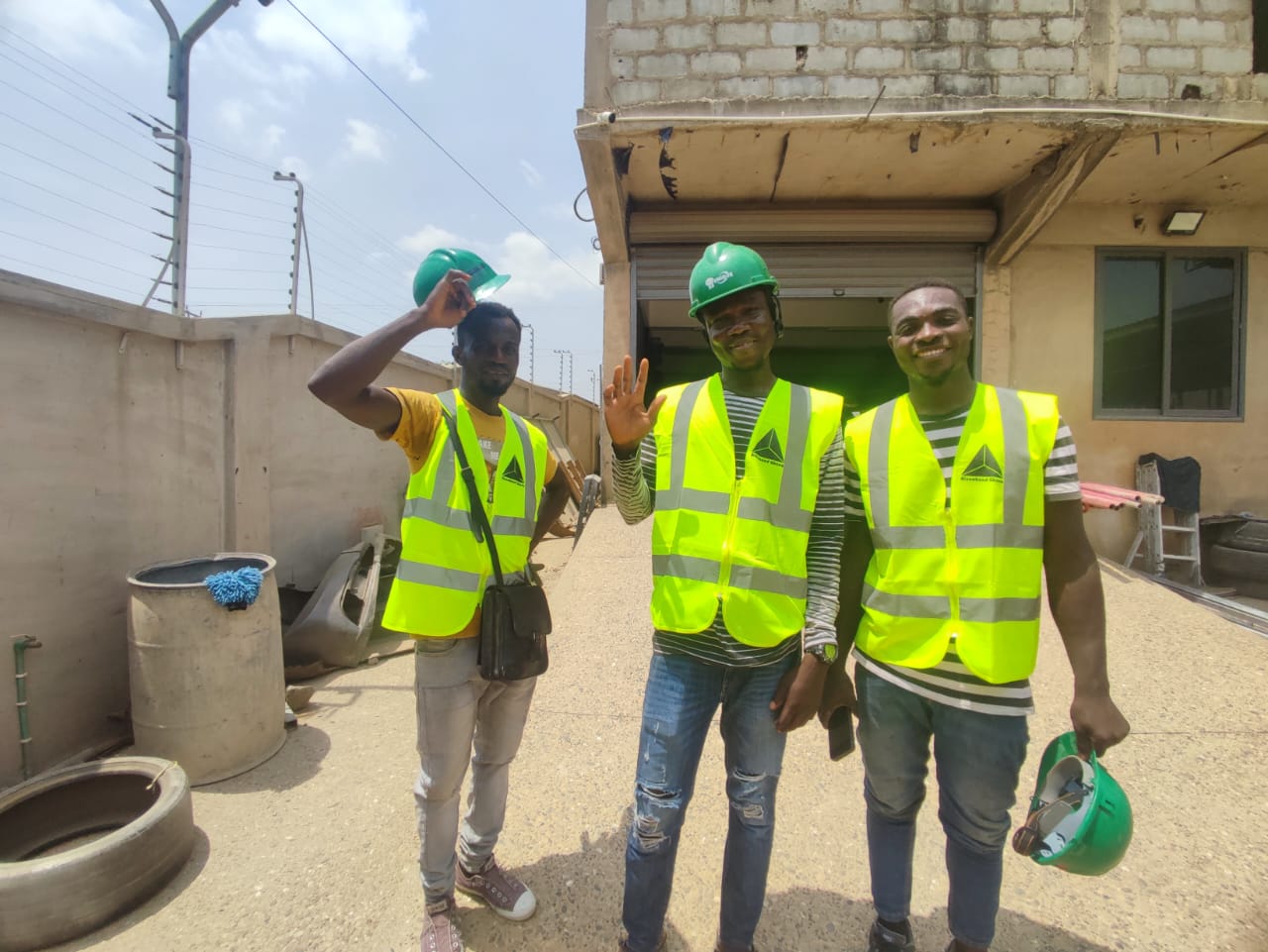 Alucobond Ghana construction team in branded high-visibility vests and hard hats on a building installation site in Ghana