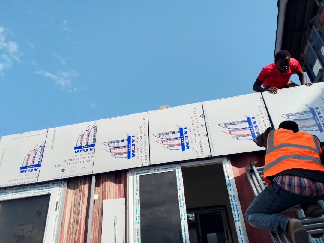 Alucobond Ghana workers fitting aluminium panels on a building exterior in Ghana
